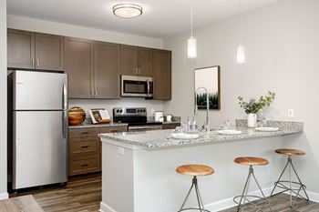 Fitted kitchen with island dining